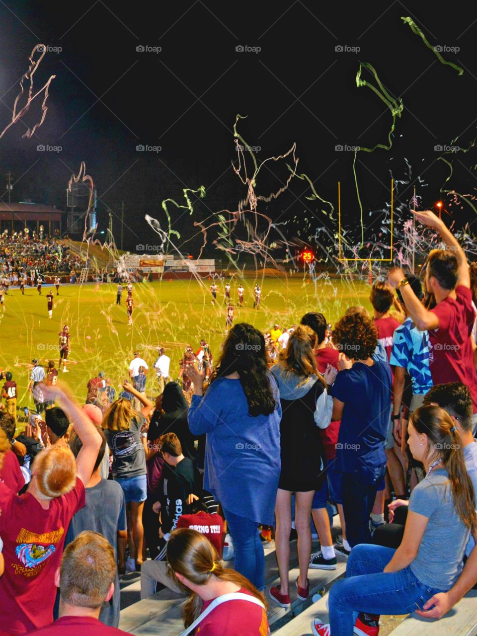 Clash of colors - High School students in colorful clothing cheering their favorite team on