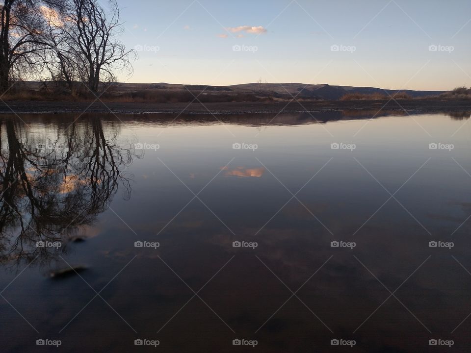 Reflection of sunset in a puddle.