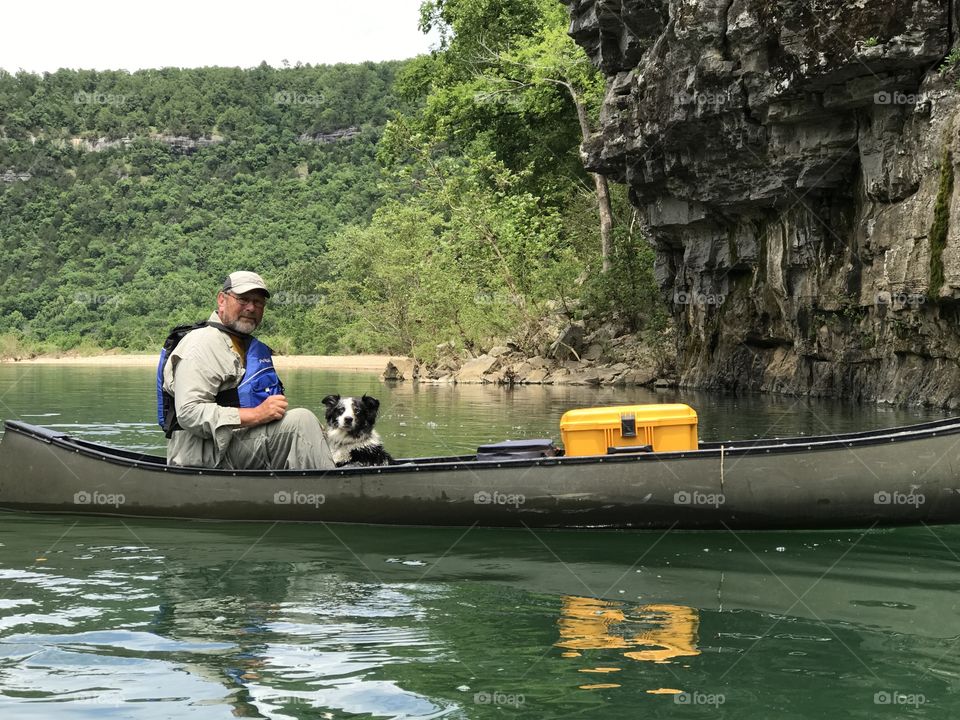 A man and his dog, floating down the river. Taken at the buffalo river in Arkansas. 
