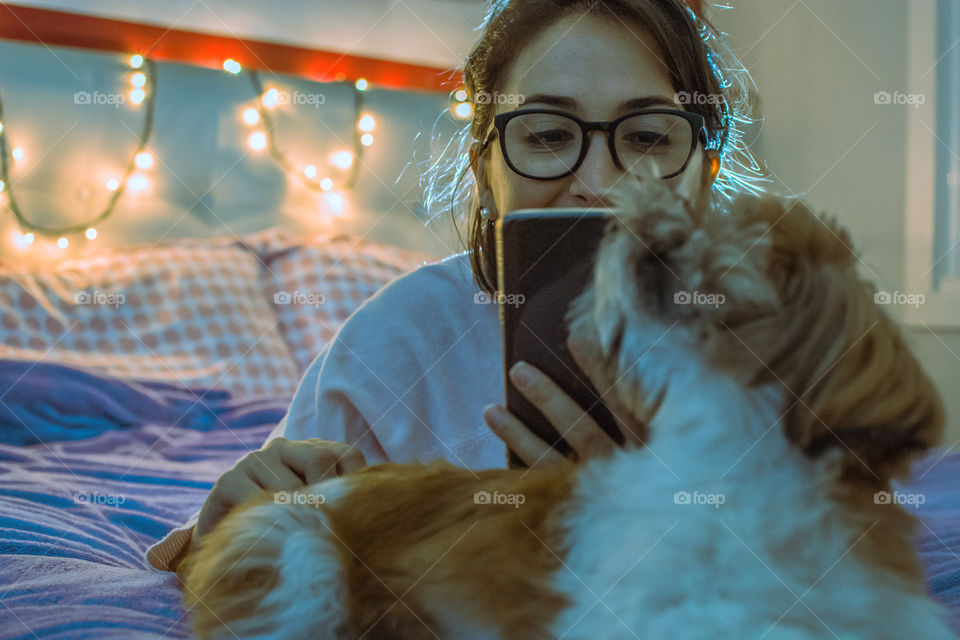 Girl taking a photo of her dog