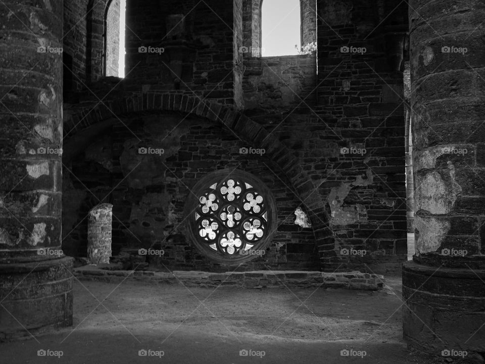 Beautiful view of the round carved window in the ancient ancient wall of the ruined monastery of Villers la Ville in Belgium, close-up side view. Concept detailed architecture of ancient castles.