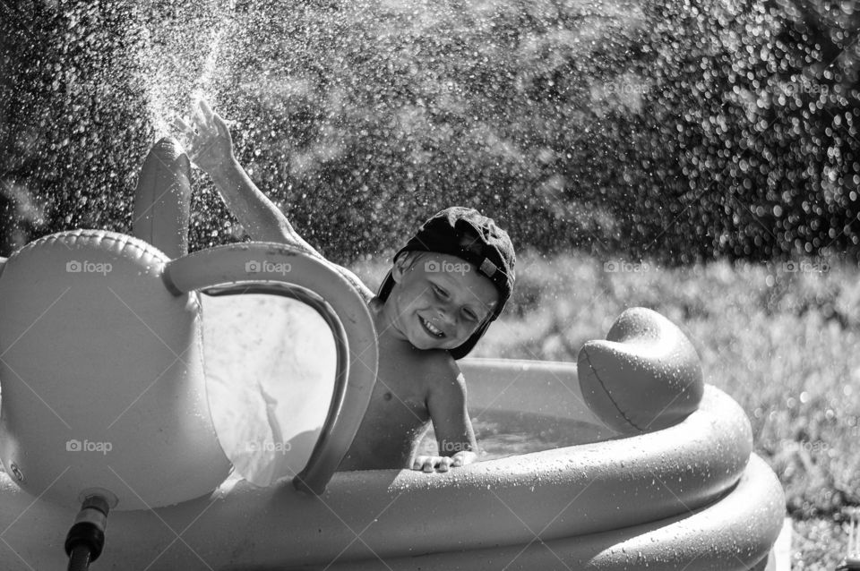 Playing in the pool. Todler boy. Black and White.