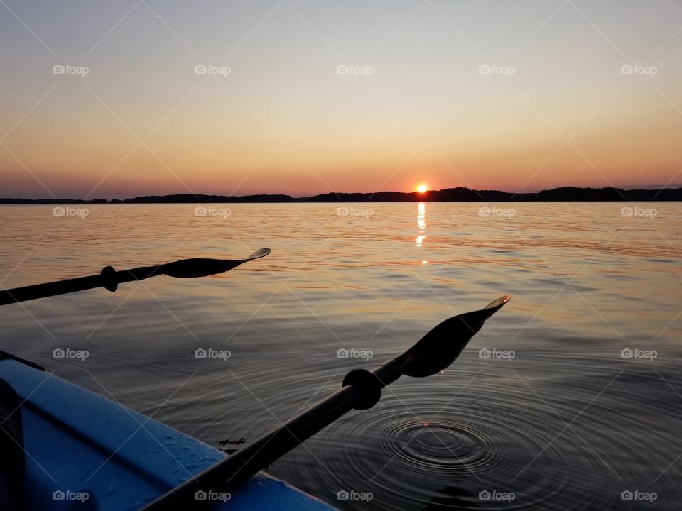 Kayaking on lake at sunset