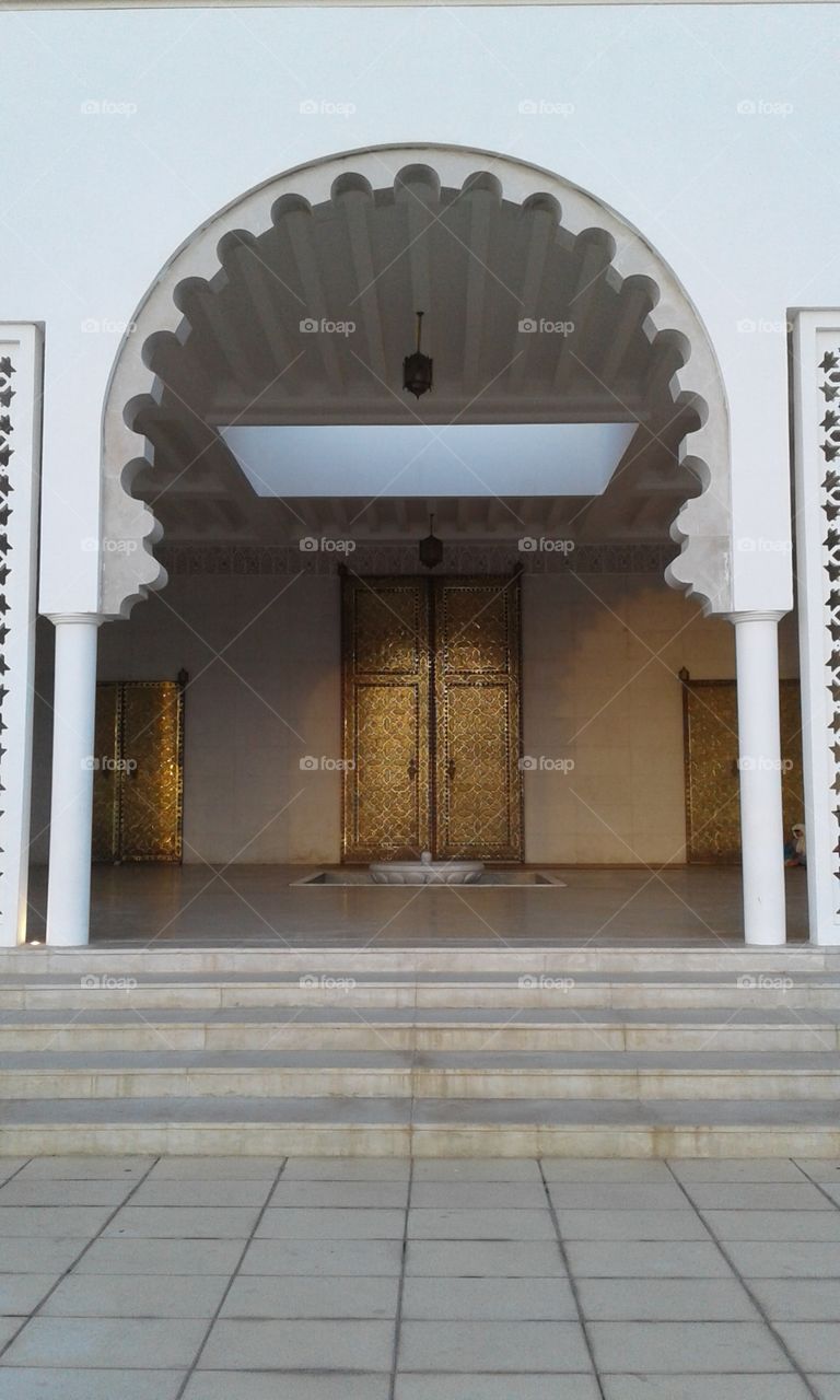 a large golden door of a mosque