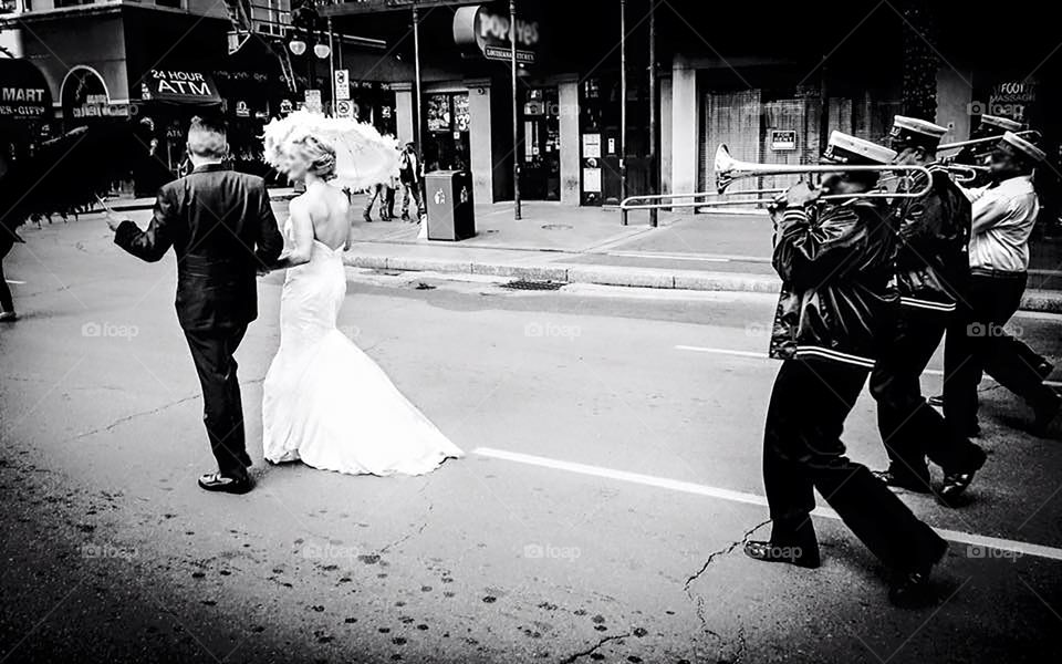 A New Orleans tradition, second lining is a festive walk led by a marching bad through the streets of NOLA. We second line for weddings, funerals, birthdays and just because. Police block off traffic for the foot parade to make its way around the city. Often they are short walks of a mile or less. In the case of this second line the bride and groom led the procession. 