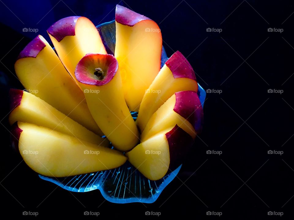 Bowl of slice apple on black background