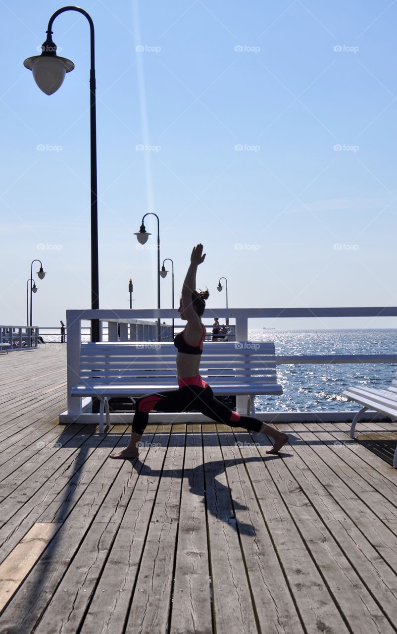 Yoga on the pier at the Baltic Sea coast in Poland 