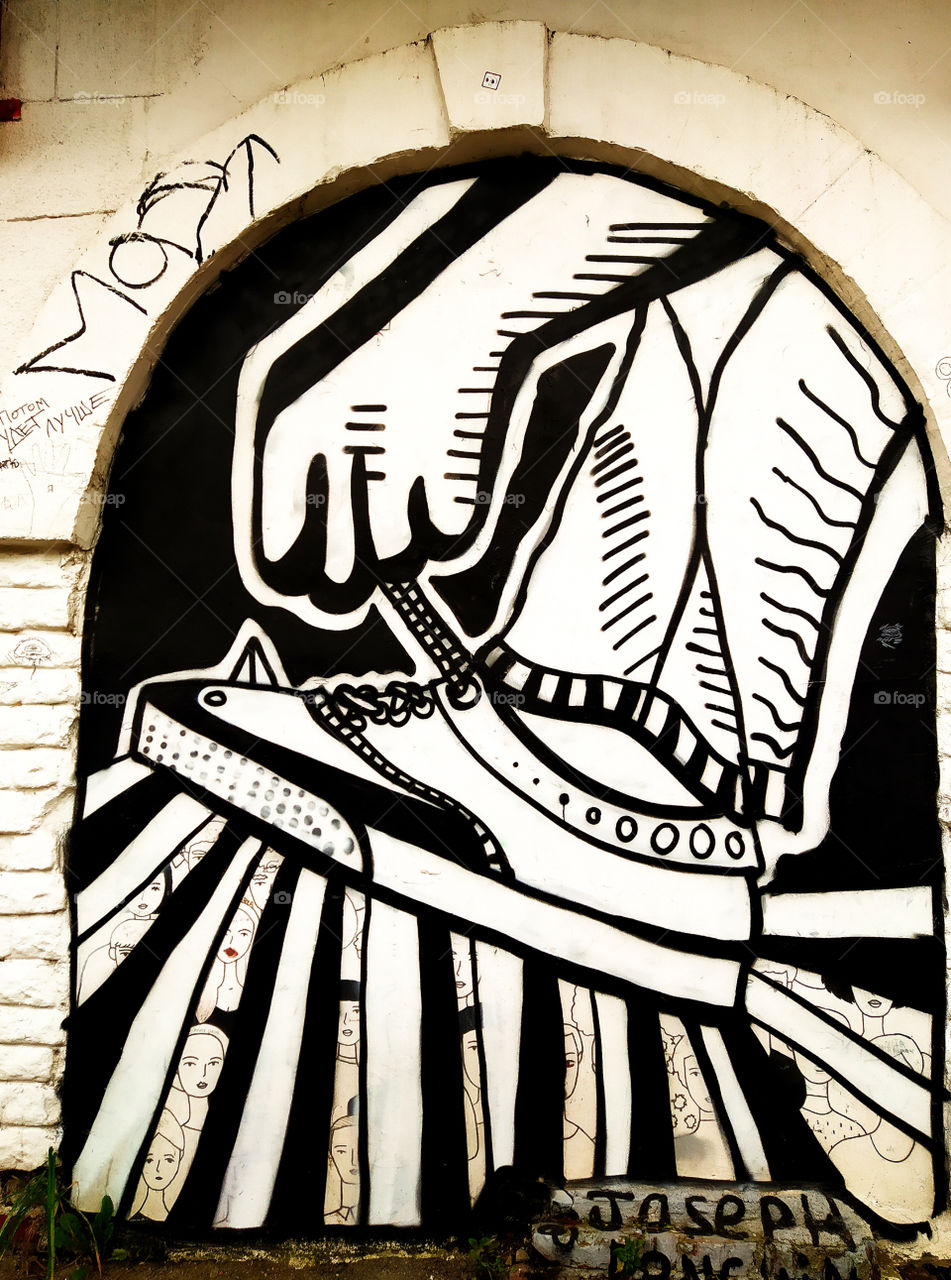 Graffiti black and white.  Tie a boot