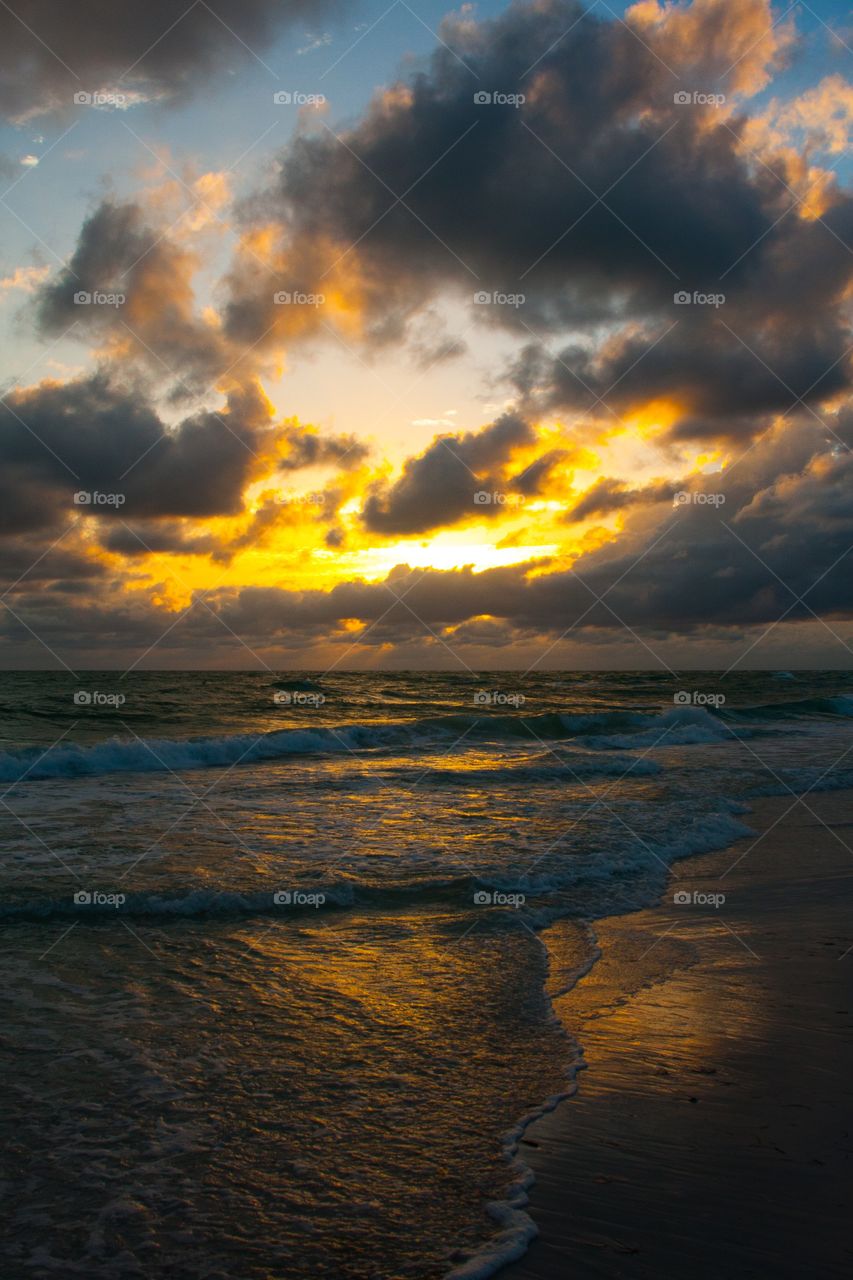 Yellow sunset over cloudy ocean