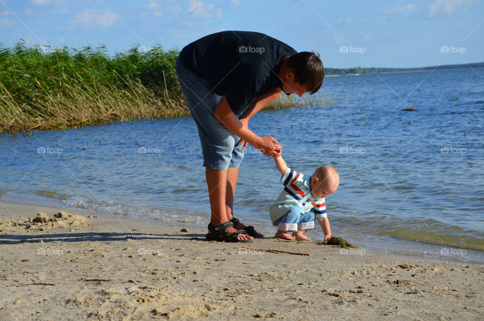 Father and son near the river