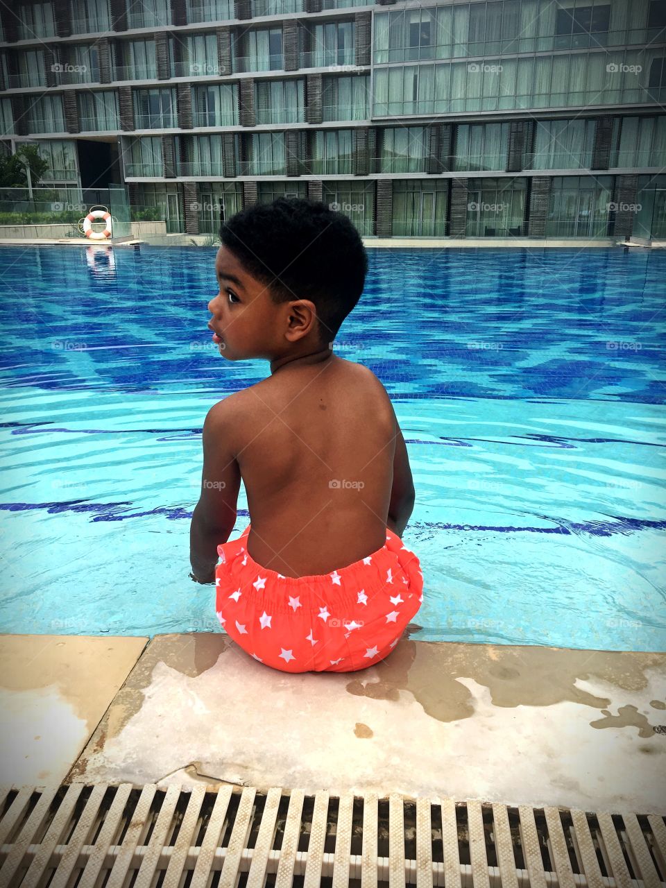 My son chilling by the pool in Ghana 