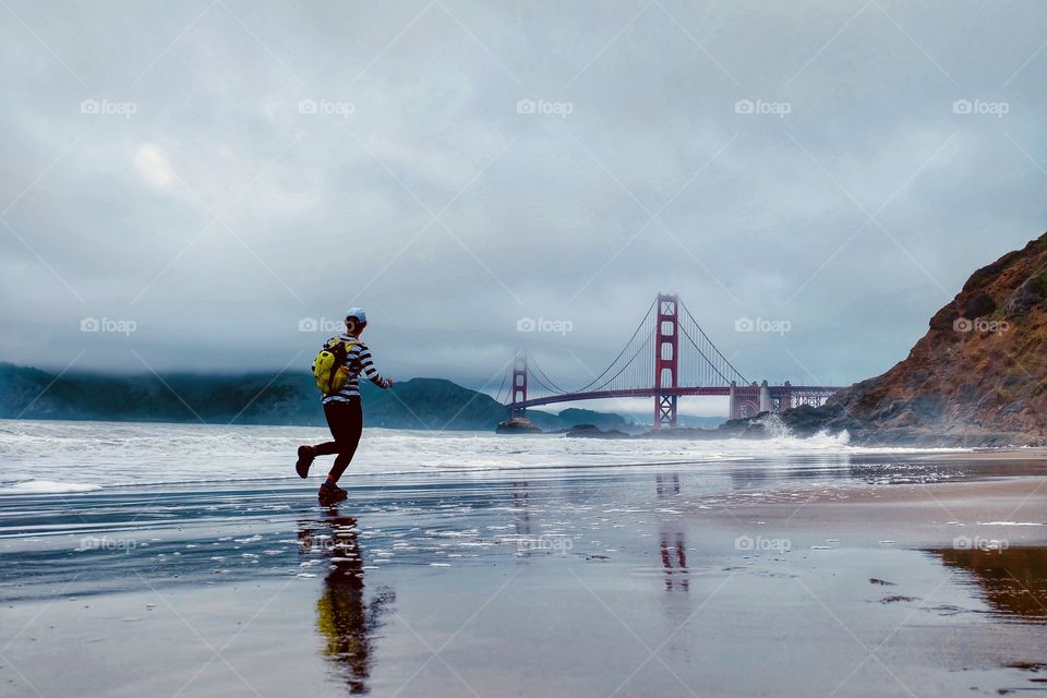 A woman running on the beach in San Francisco 