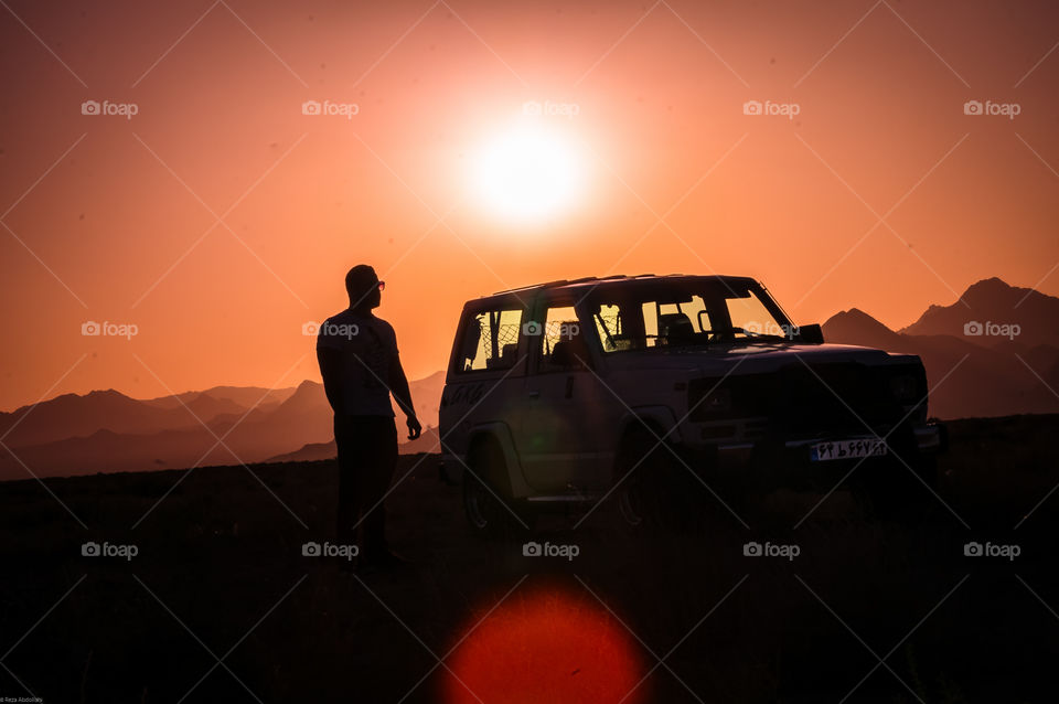 paint it red or black. Offroad trip to the desert with a handsome guy and his powerful patrol at sunset silouette