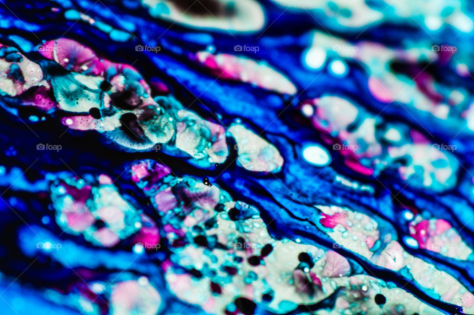 The ink to refill the printer cartridge was spilled onto the white washbasin and the paints blended into abstract drips and patterns.