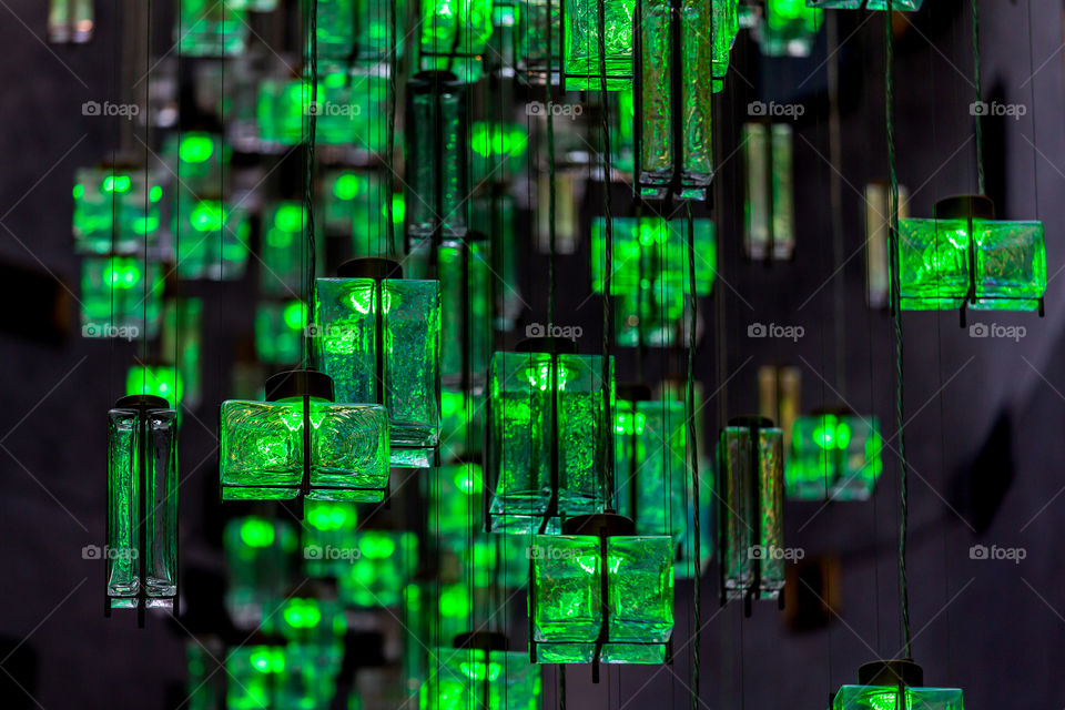 Modern green lanterns hanging up from the ceiling