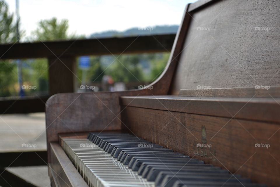 Piano by the sea on a wharf. Old piano  on public dock, provided by the city to promote the performing arts, invite public participation