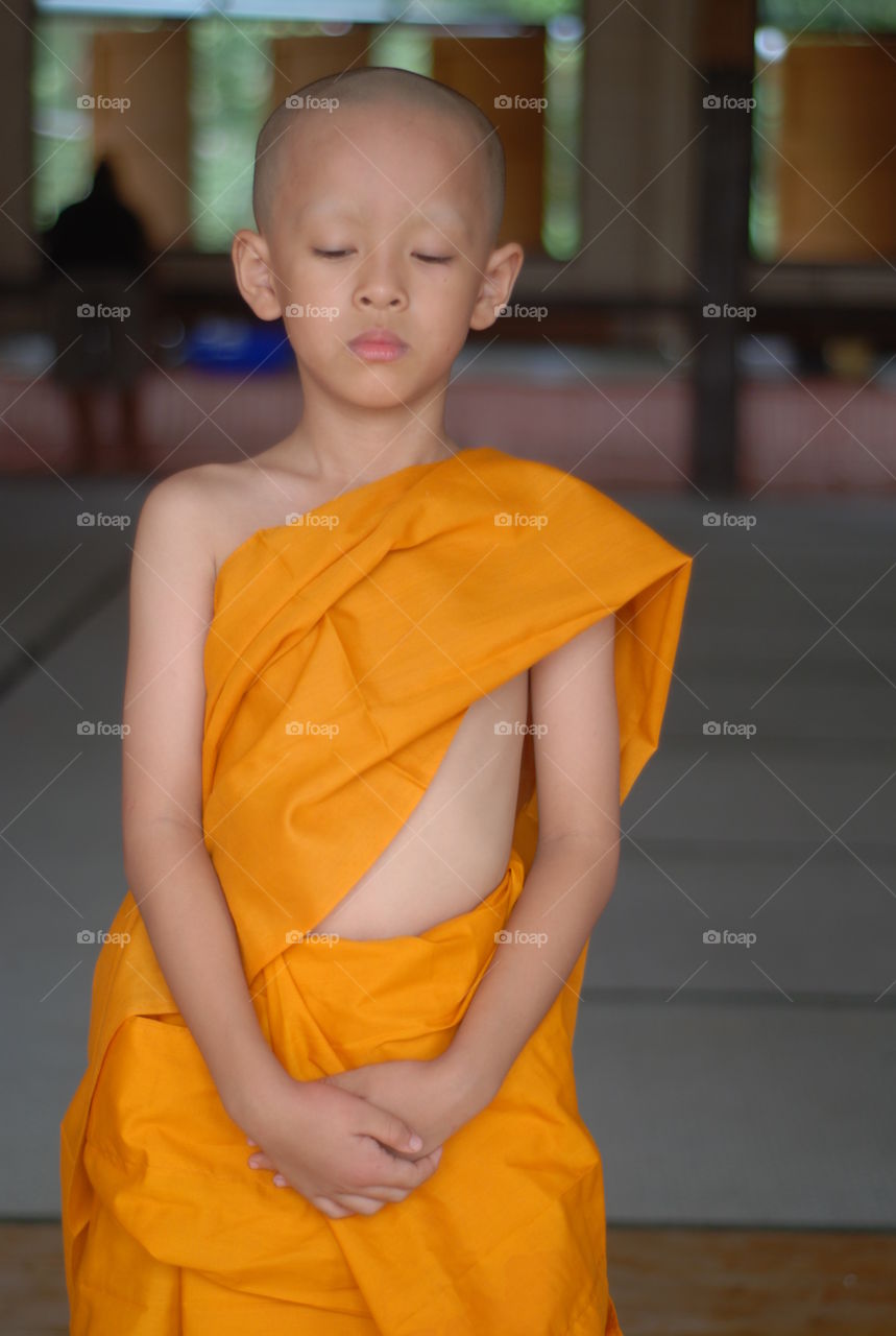 "Novice " Thai children study the teaching of the Buddha during summer.