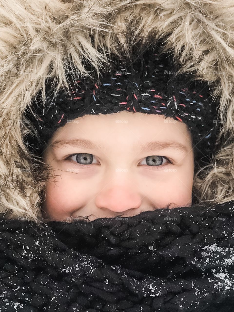 Blue eyes boy bundled up in winter