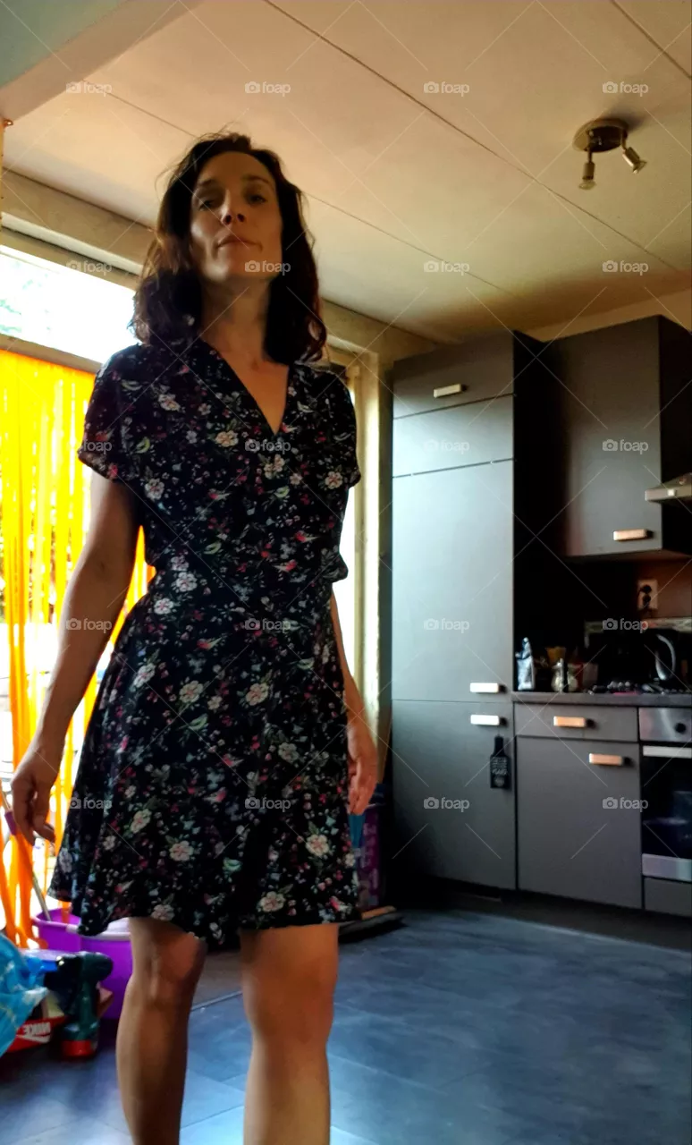 Woman walking from the kitchen to the living room