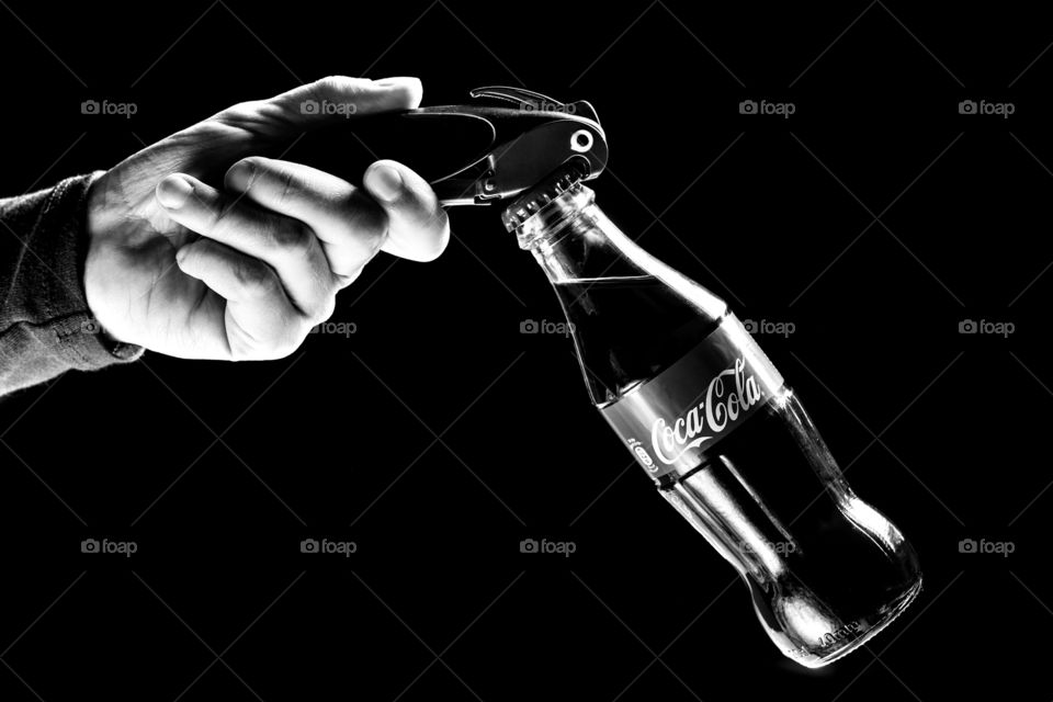 Holding the bottle with bottle opener