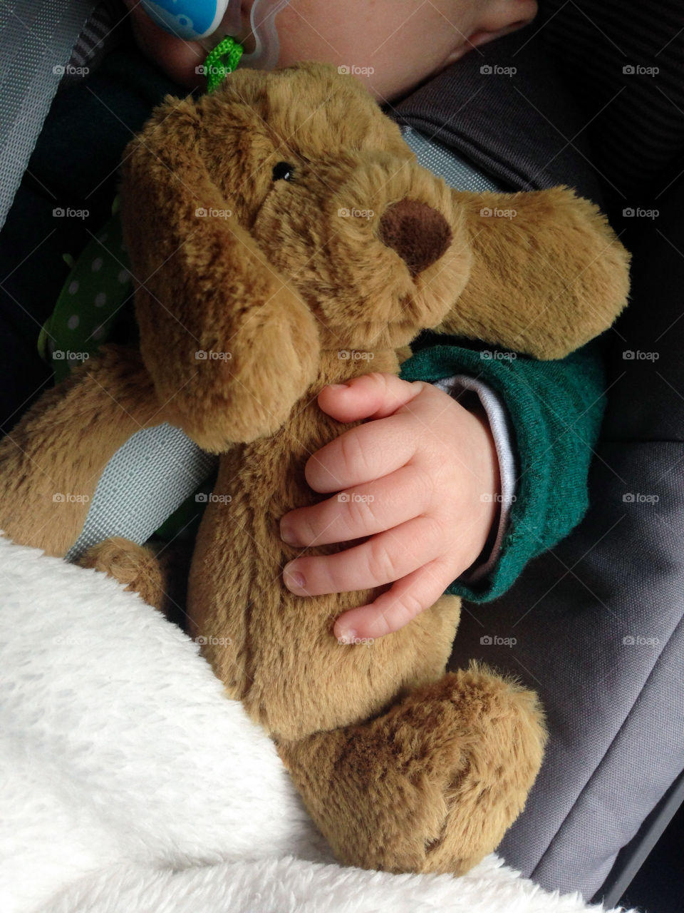 Hand of baby boy playing with toy