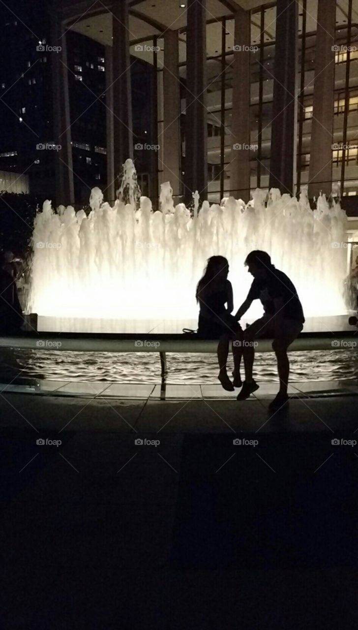 Couple in Silhouette by Fountain