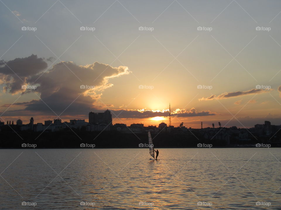 sunset and windsurfing on the river