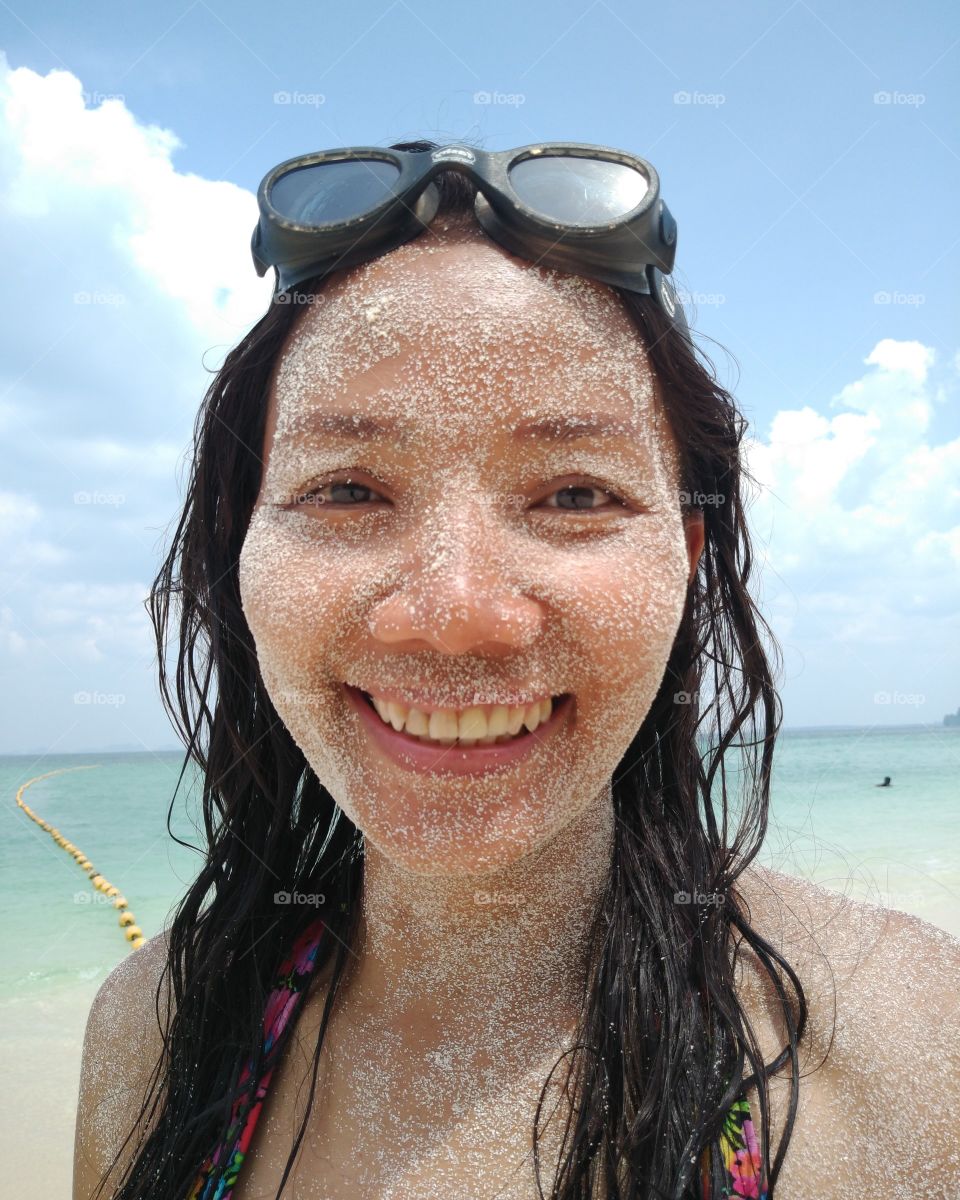 happy girl smile sand on face fun  summer sunglass sea beach enjoy