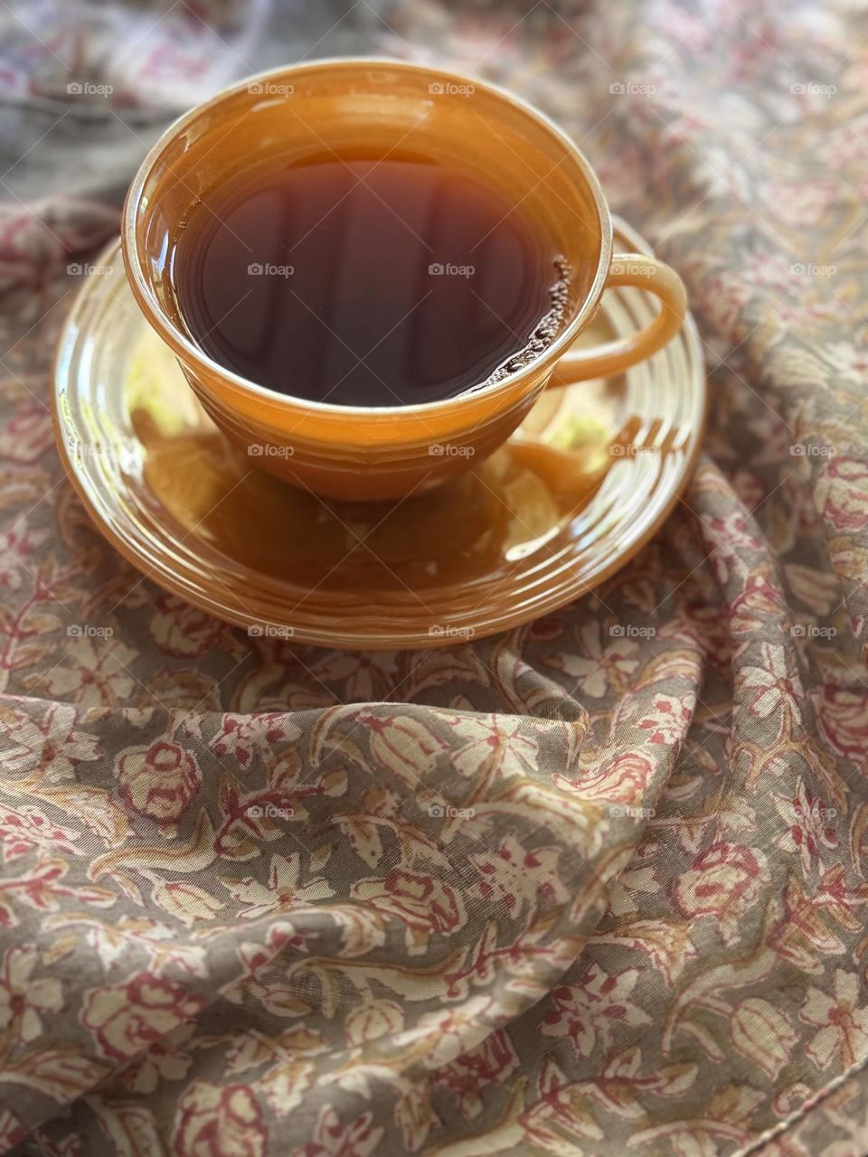 Vintage Anchor Hocking Fire King Peach Lusterware cup and saucer with tea on Anohi Indian wood block print cotton scarf