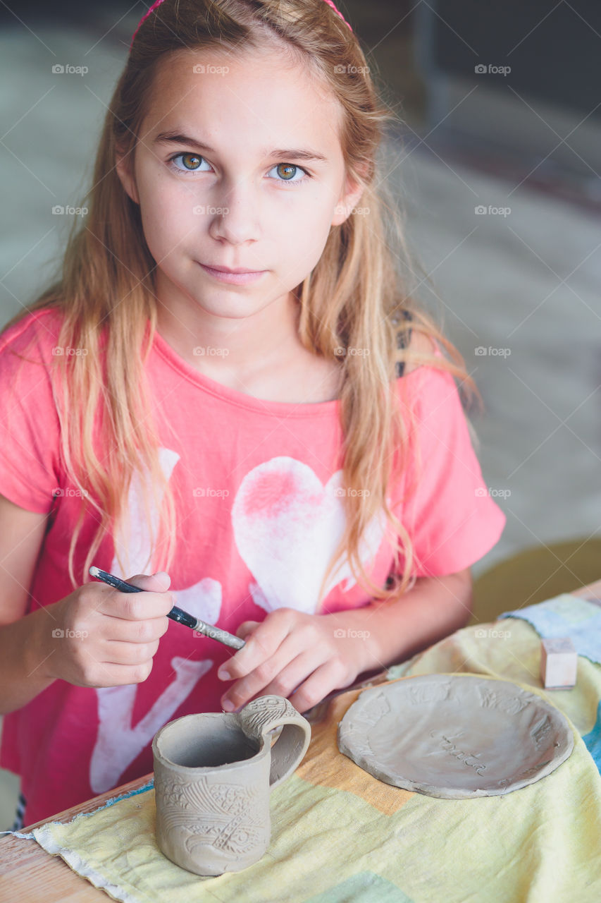 Girl with tool sitting at desk