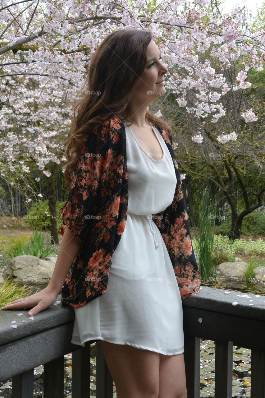 Woman standing near cherry blossom