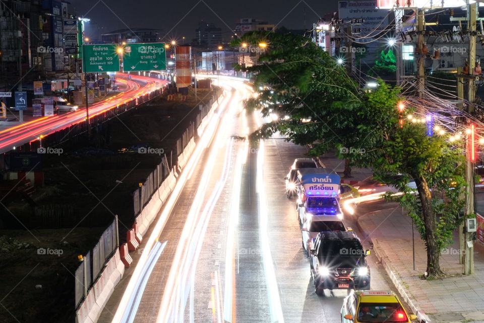 Vehicle lamp make beautiful line on road when drivers are driving back to home in evening 