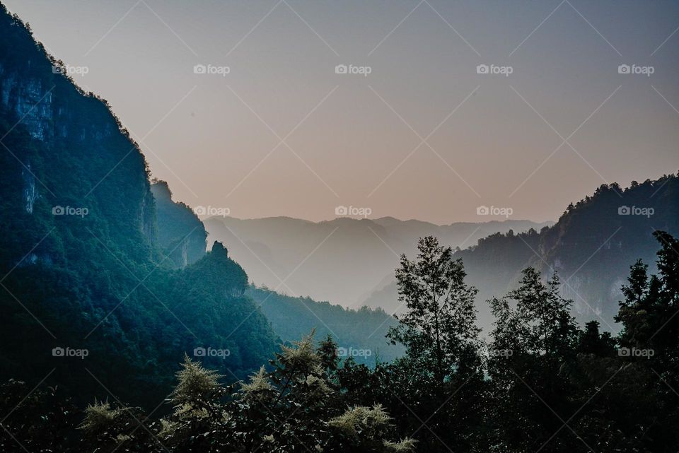 Dawn in a foggy valley