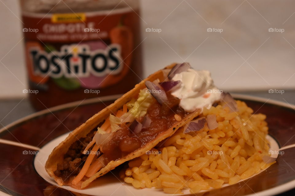 Tostitos salsa on my tacos for supper with yellow rice.