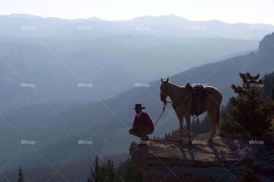 Cowboy on mountain top