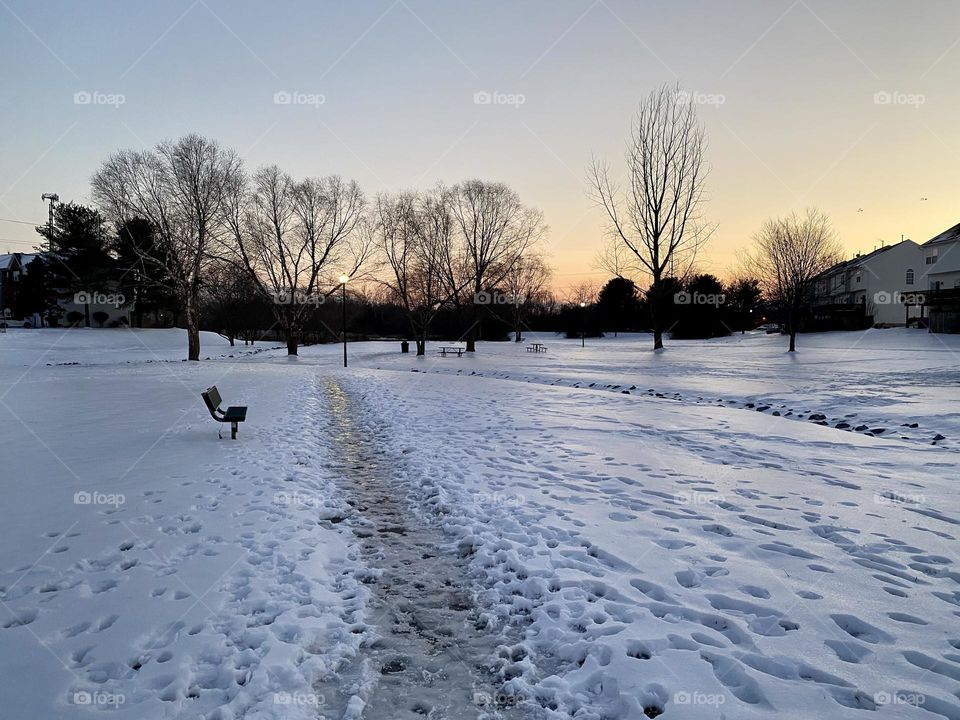 A path thru an ice and snow covered field