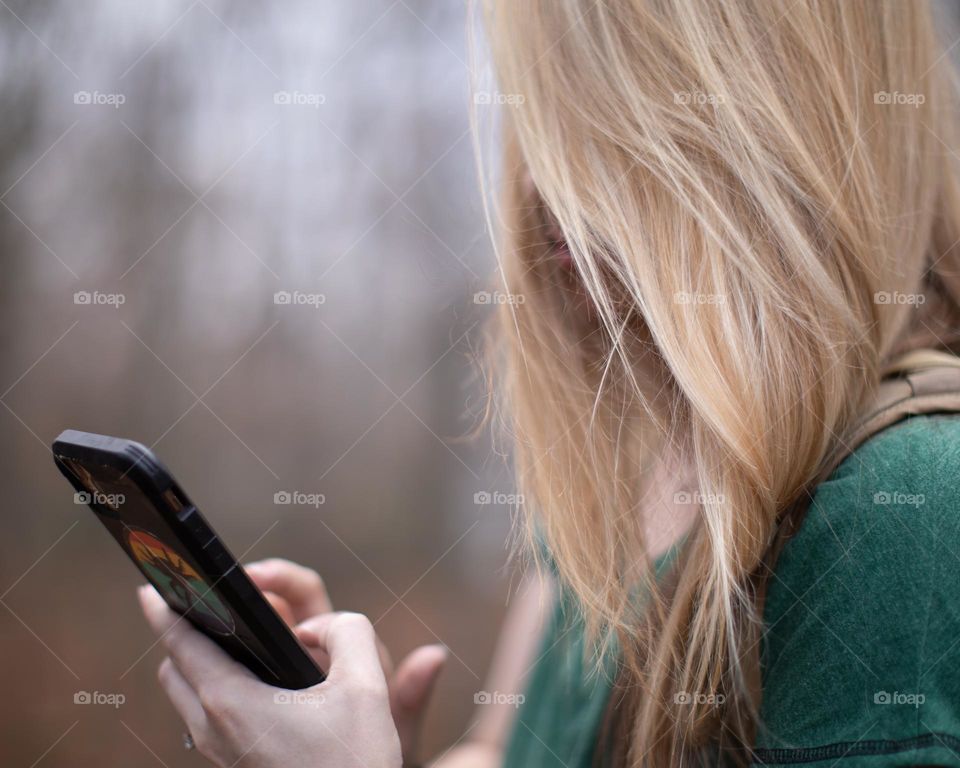 Woman using her phone to navigate the outdoors