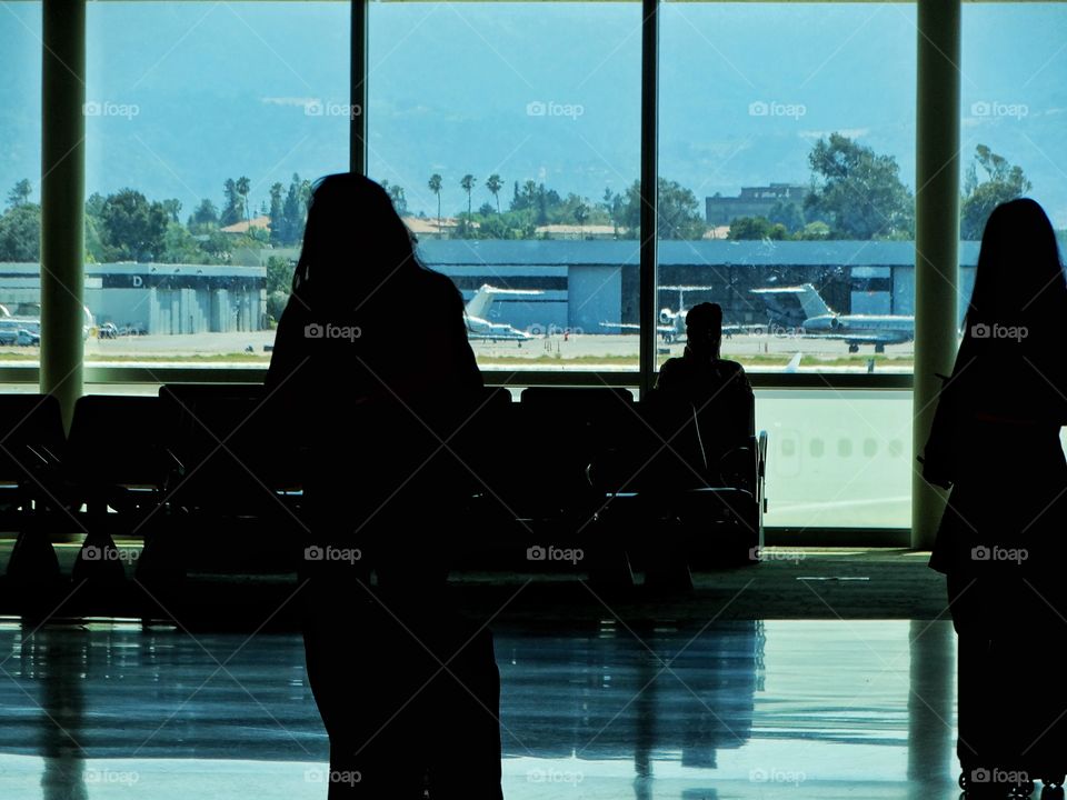 Passengers Waiting In An Airport Departure  Terminal
