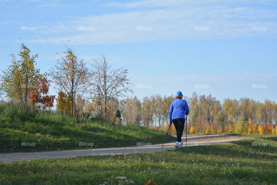 woman sport walking  on a road autumn landscape