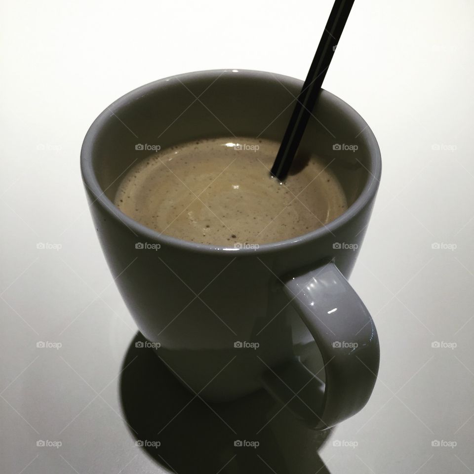 High angle view of coffee with straw