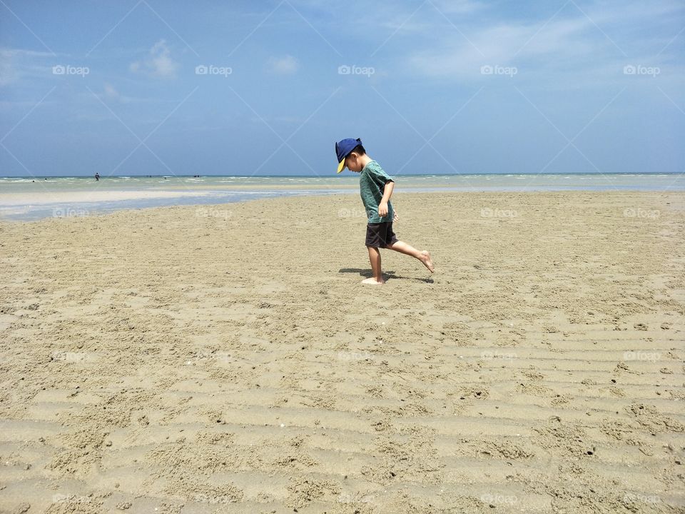 boy playing at beach