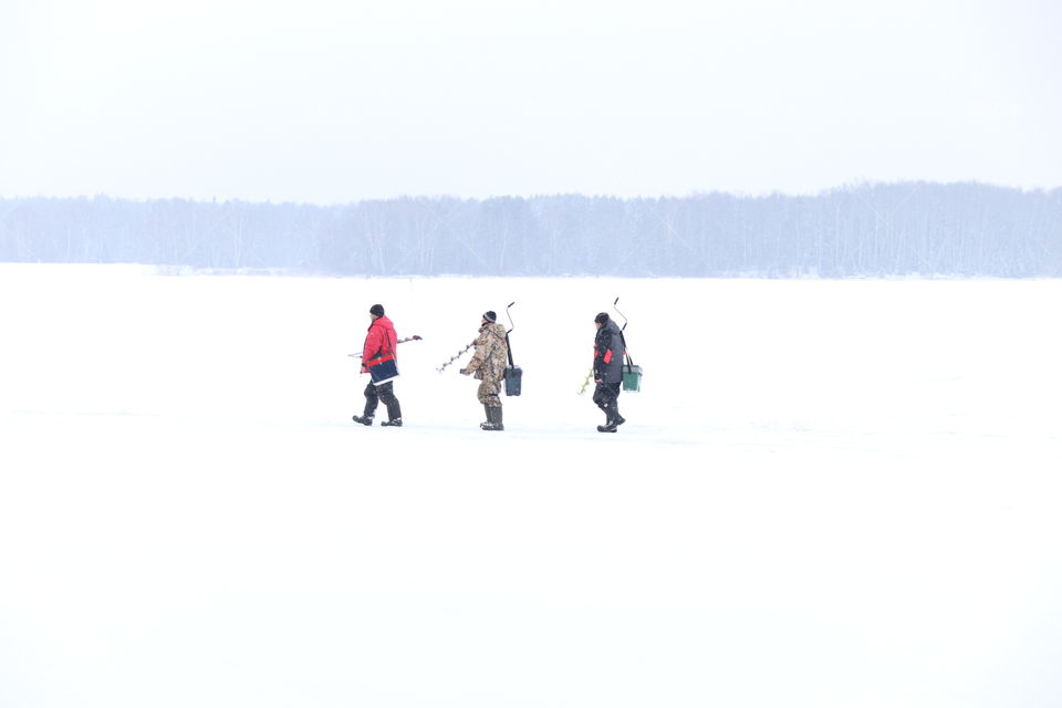 three fishermen in winter