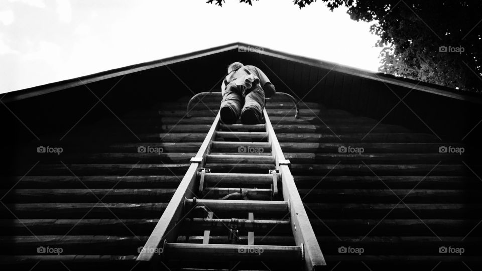 Man cleaning log home
