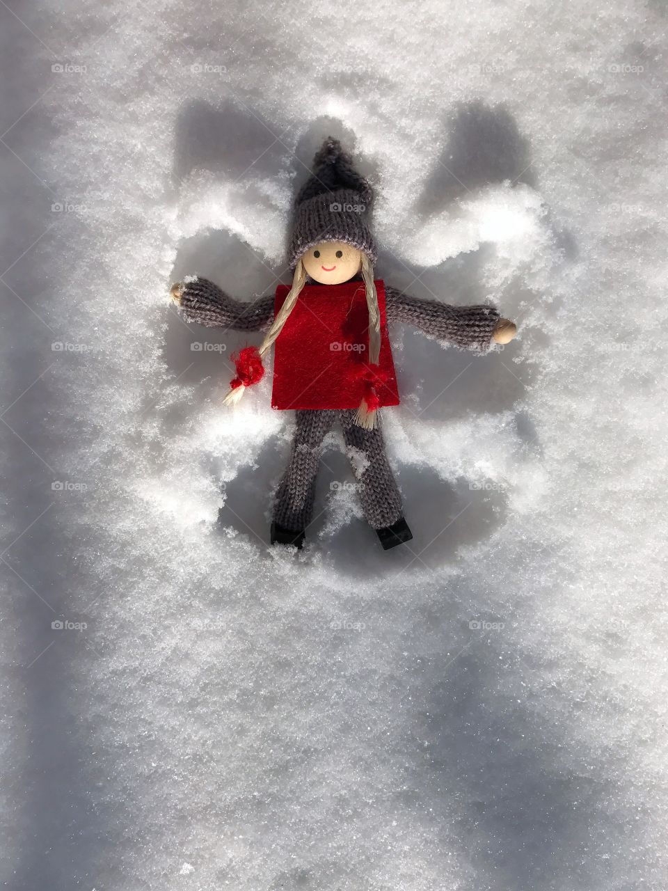 Wooden toy on the white snow 