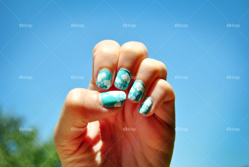 Clouds and rain nail art design against clear sky background