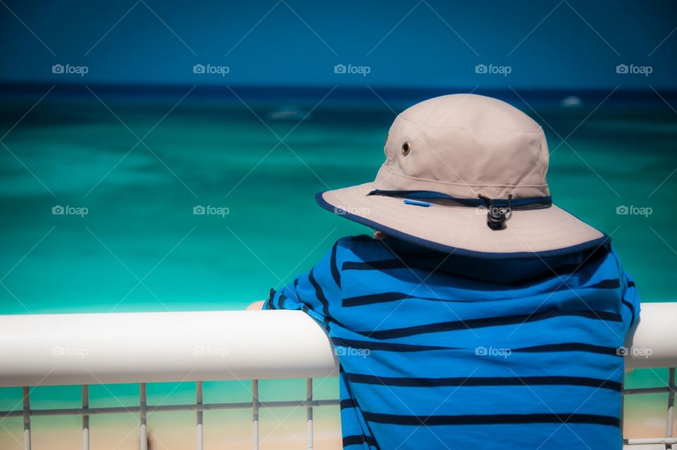 Child looking out at ocean