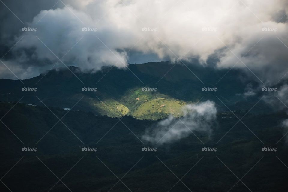 A game of light and shadow over a mountain