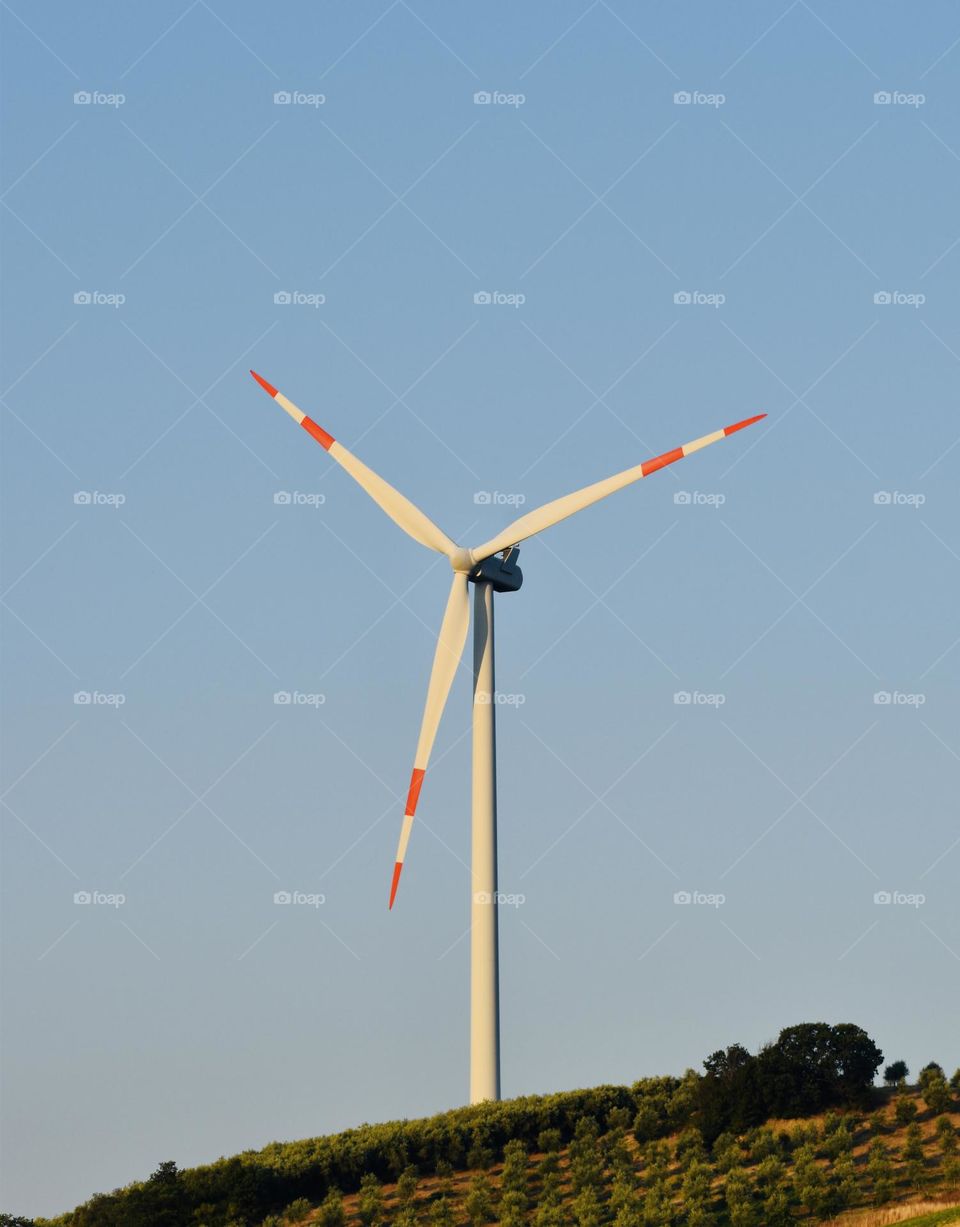 Wind turbine tower at sunrise 