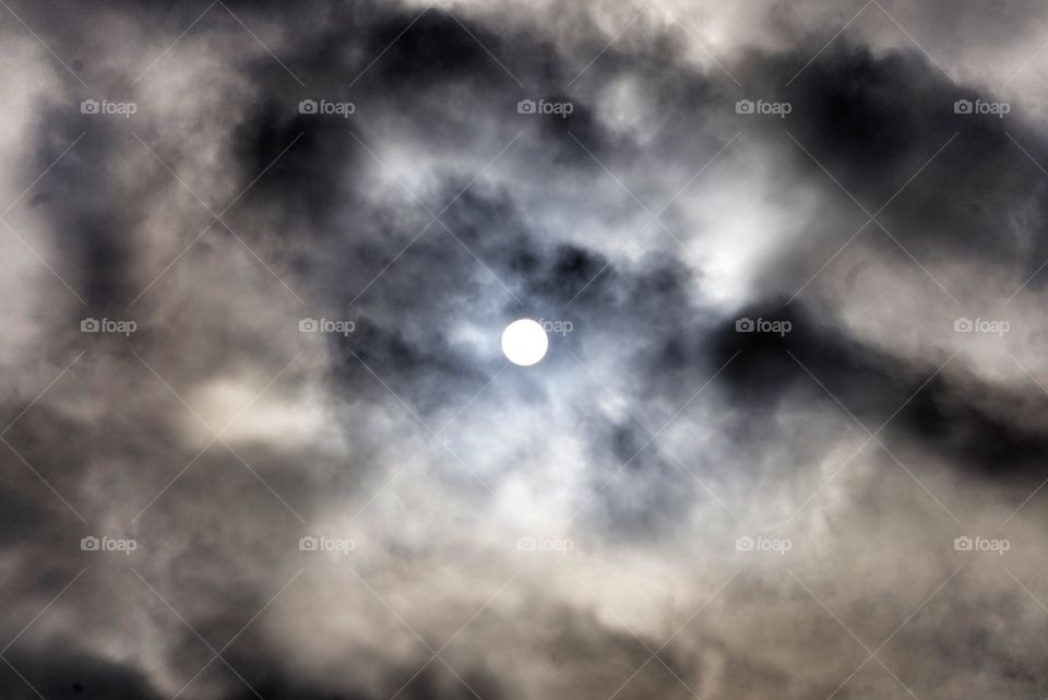 sun behind the clouds