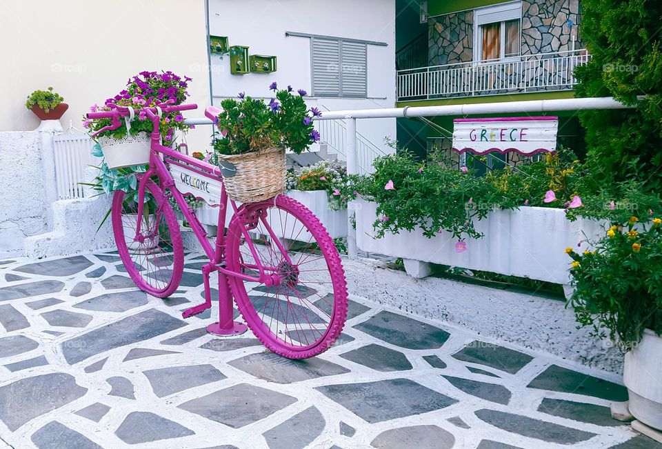 Lonely pink Greek bicycle